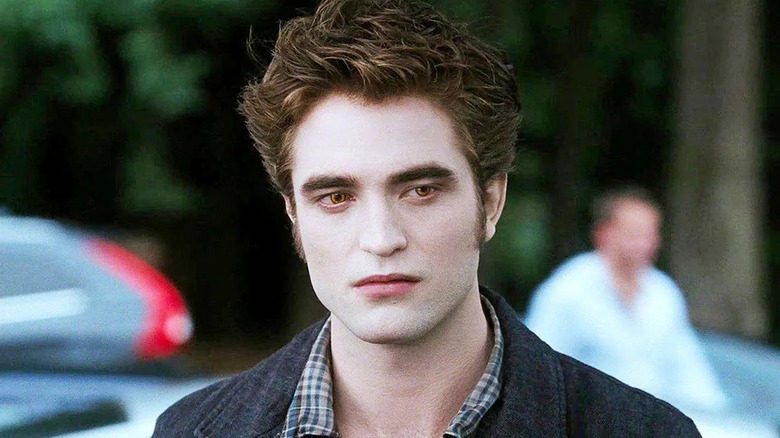 Robert Pattinson as Edward Cullen in the school parking lot in Twilight