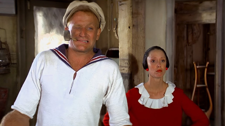 Robin Williams as Popeye stands next to Shelley Duvall as Olive Oyl in in Popeye