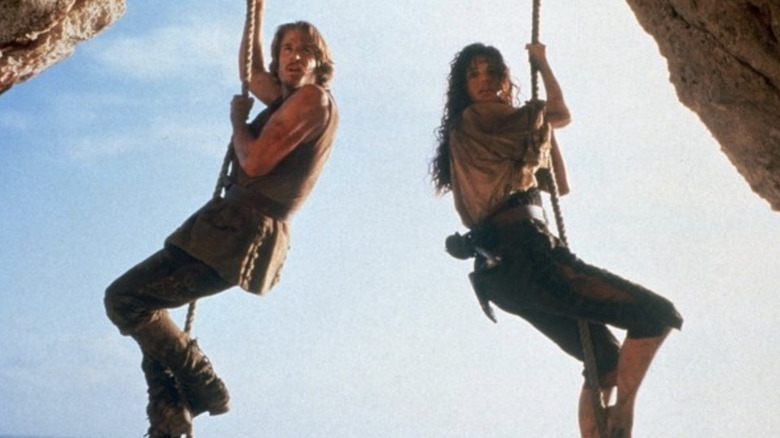 William Shaw (Matthew Modine) and Morgan Adams (Geena Davis) dangle from ropes in Cutthroat Island