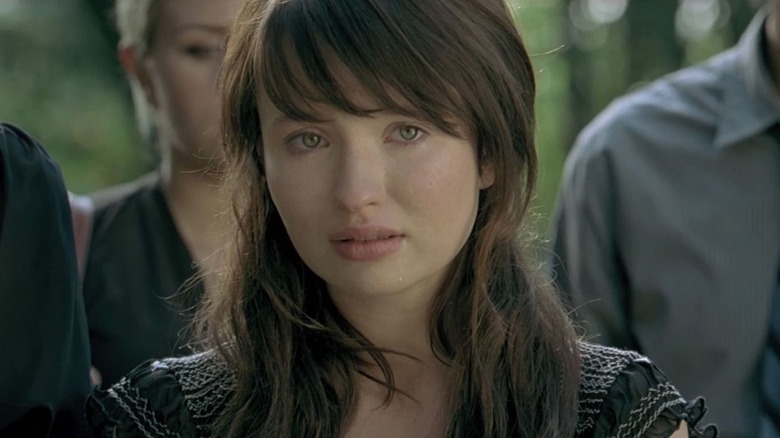 Anna Ivers (Emily Browning) stands emotionally in a crowd in The Uninvited