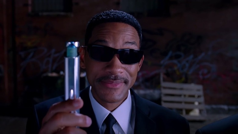 Agent J (Will Smith) holds up a neuralyzer in Men in Black II
