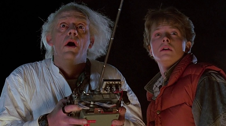 Christopher Lloyd as Doc Brown and Michael J Fox as Marty McFly, holding a controller with a big antenna, in Back to the Future