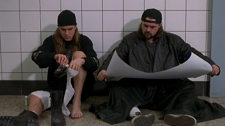 Jason Mewes and Kevin Smith as Jay and Silent Bob, sitting on the ground in Mallrats