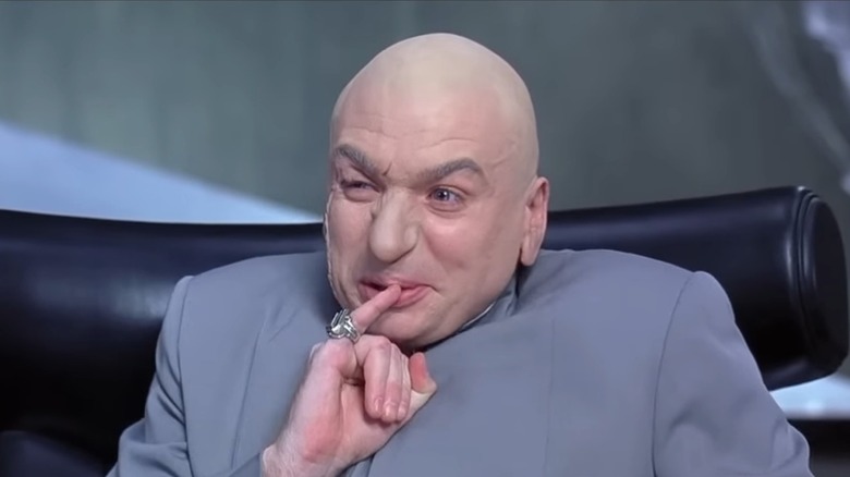 Mike Myers as Dr. Evil, holding his pinky to his lips, in Austin Powers: International Man of Mystery