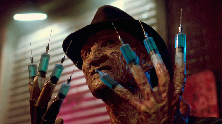 Robert Englund as a smiling Freddy Krueger with needle hands in A Nightmare on Elm Street 3: Dream Warriors