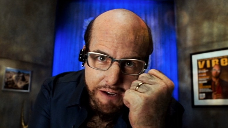 Tom Cruise as Les Grossman clenching a fist and looking into the camera in Tropic Thunder
