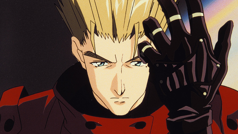 Vash the Stampede adjusts his glove in Trigun