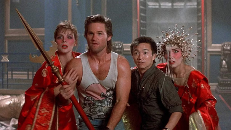 Kim Cattrall as Gracie, Kurt Russell as Jack, Dennis Dun as Wang, and Suzee Pai as Miao, ready to fight in Big Trouble in Little China
