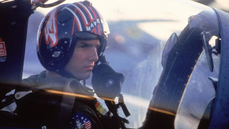 Pete Mitchell (Tom Cruise) sits in a cockpit with his mask off in Top Gun