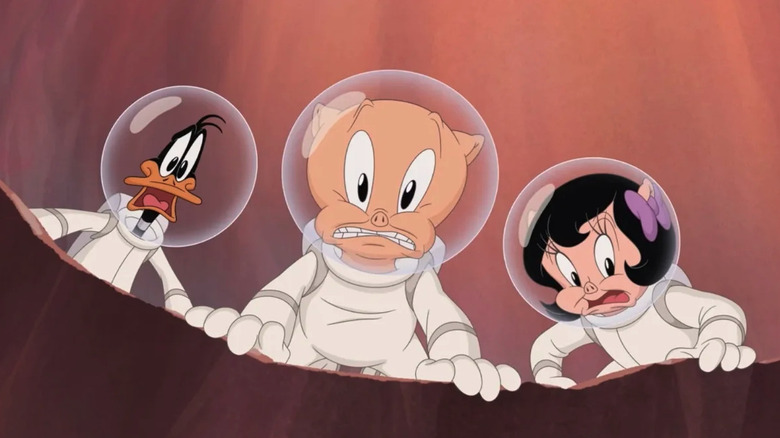 Porky Pig, Daffy Duck, and Petunia Pig in spacesuits looking down into a hole in The Day The Earth Blew Up: A Looney Tunes Movie