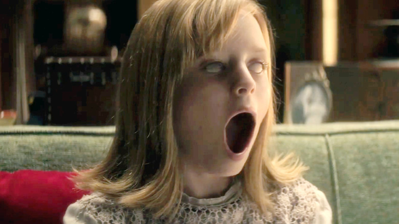 Lulu Wilson as Doris Zander, eyes white and jaw unhinged in Ouija: Origin of Evil