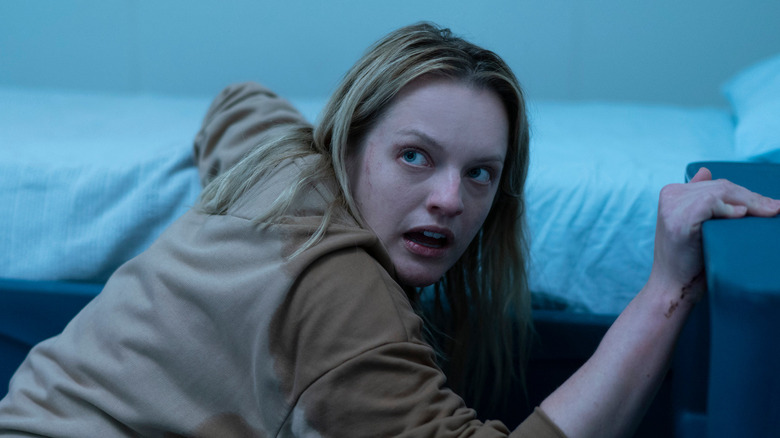 Elisabeth Moss as Cecilia Kass, looking scared over her shoulder in The Invisible Man