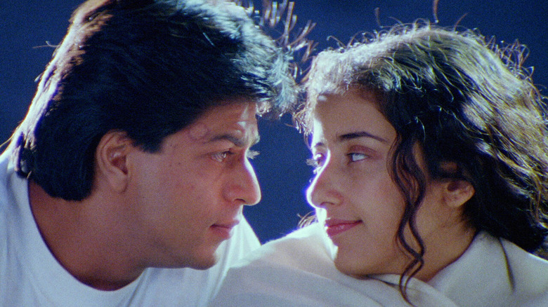 Close-up of Shah Rukh Khan as Amar and Manisha Koirala as Meghna, both in white looking at each other in Dil Se...