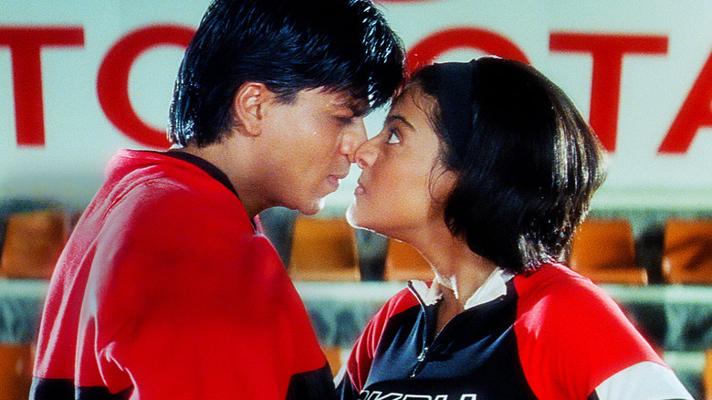 Shah Rukh Khan as Rahul and Kajol as Anjali, nose to nose on a basketball court in Kuch Kuch Hota Hai