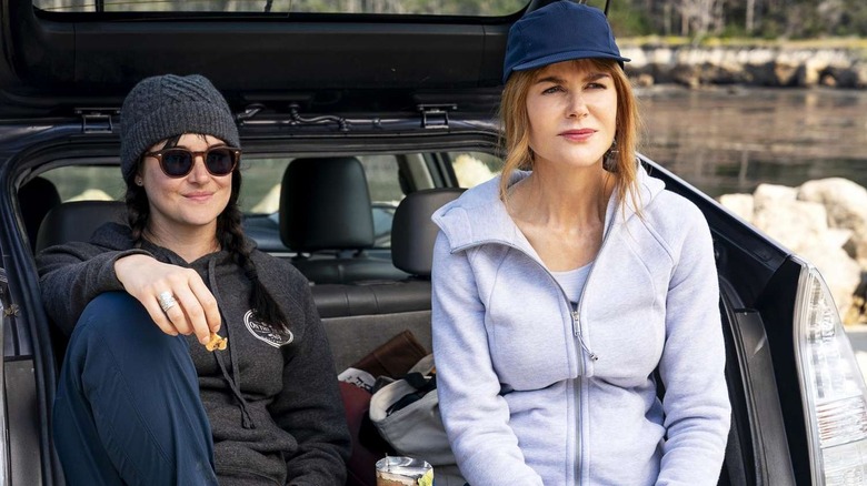 Jane Chapman (Shailene Woodley) and Celeste Wrightr (Nicole Kidman) sit in an open car trunk in Big Little Lies