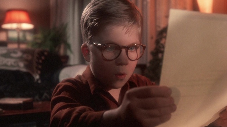 Ralphie Parker (Peter Billingsley) looks intently at a piece of paper in A Christmas Story