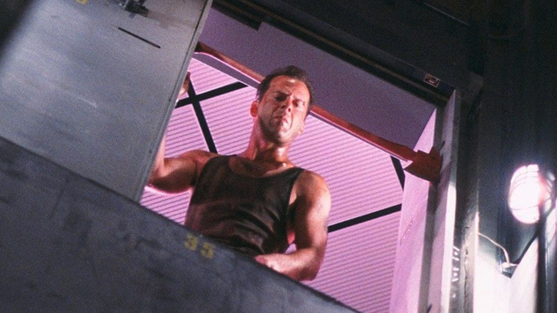 John McClane (Bruce Willis) looks down an elevator shaft in Die Hard