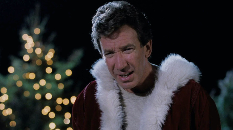 Scott Calvin (Tim Allen) stares confusedly while wearing a Santa Claus coat in The Santa Clause