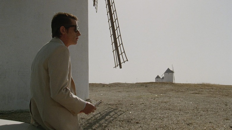 John Hurt as Mitchell Braddock, waiting under a windmill in The Hit