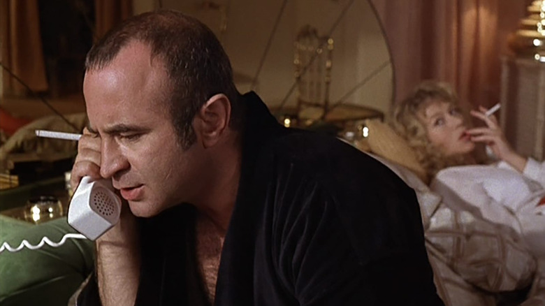 Helen Mirren as Victoria watches Bob Hoskins as Harold Shand take a phone call in The Long Good Frida