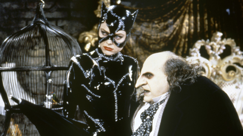 The Penguin (Danny DeVito) and Catwoman (Michelle Pfeiffer) standing together in Batman Returns