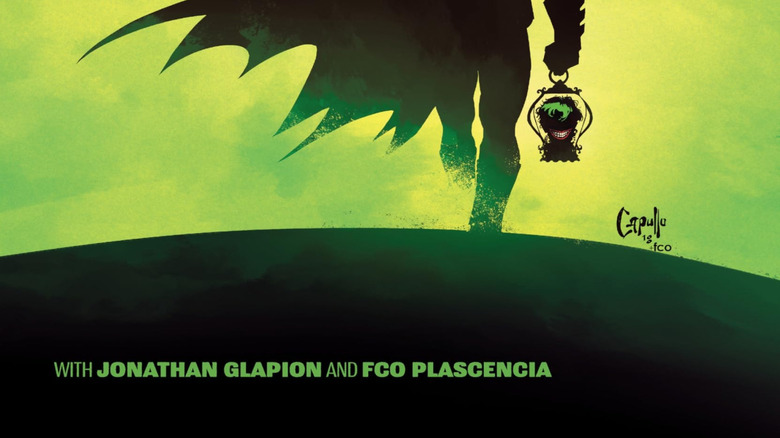 Batman marches through a green fog with the Joker's head in a lantern