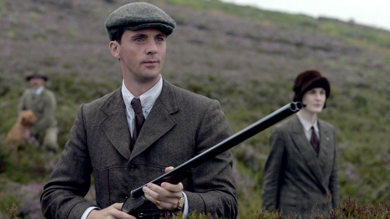 Henry Talbot (Matthew Goode) surveys the landscape with a rifle as Mary Crawley (Michelle Dockery) watches in Downton Abbey