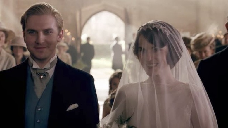 Matthew Crawley (Dan Stevens) and Mary Crawley (Michelle Dockery) walk down the aisle at their wedding in Downton Abbey