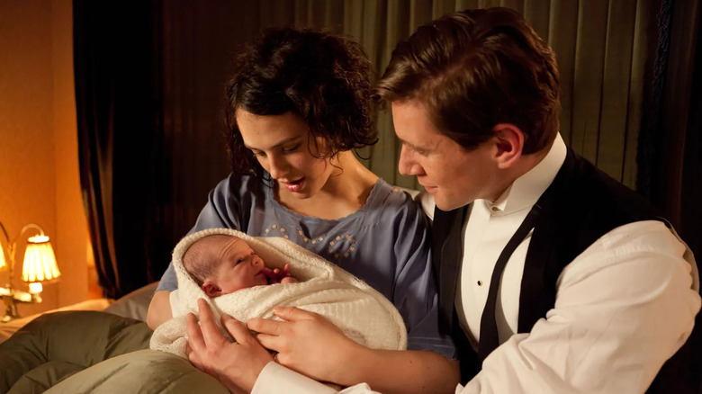 Sybil Branson (Jessica Brown Findlay) and Tom Branson (Allen Leech) admire their baby in Downton Abbey