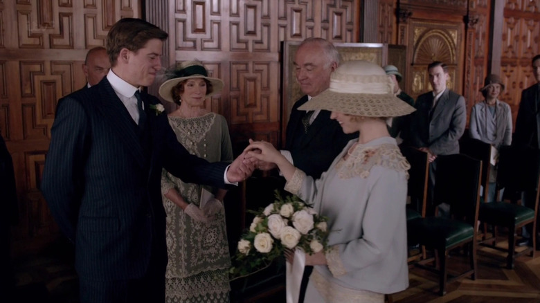Atticus Aldridge (Matt Barber) takes the hand of Rose MacClare (Lily James) at their wedding in Downton Abbey