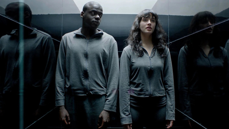 Bing (Daniel Kaluuya) and Abi (Jessica Brown Findlay) standing together in Black Mirror