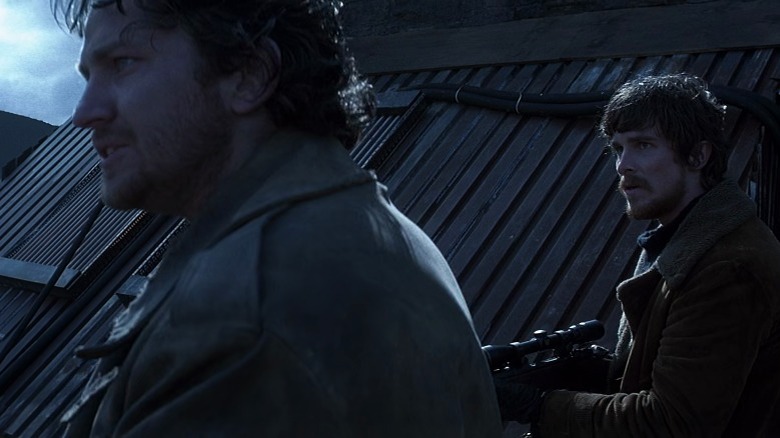 Reign of Fire's Creedy and Quinn Abercromby holding guns and scanning the horizon