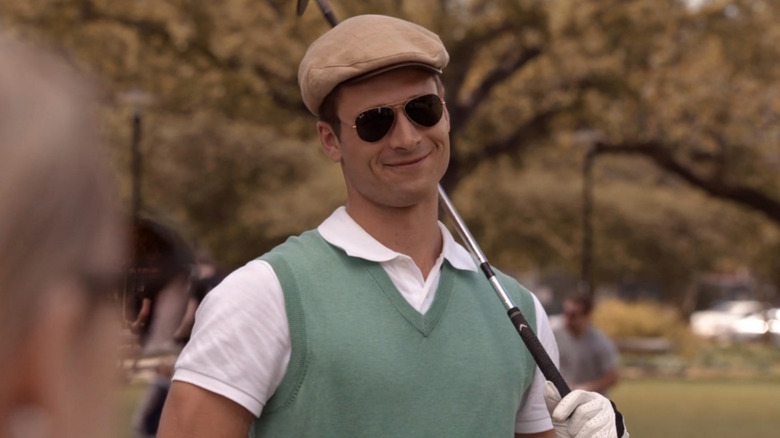 Chad (Glen Powell) smirking in golf attire in Scream Queens