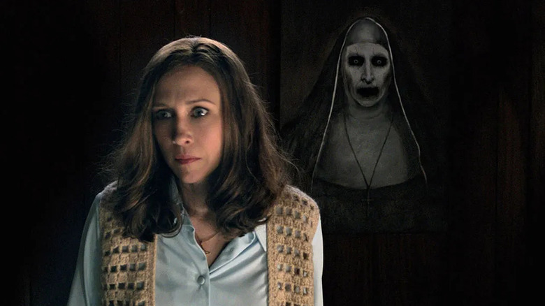 Vera Farmiga as Lorraine Warren, standing in front of Valak the Nun in The Conjuring 2