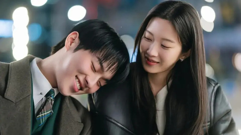 Ban Joo-yeon (Choi Hyun-wook) smiles and rests his head on the shoulder of Baek Soo-jung (Moon Ga-young) in My Dearest Nemesis