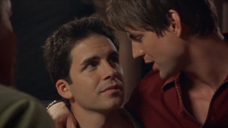 Gale Harold as Brian with arm around and looking down at Hal Sparks as Michael in Queer as Folk