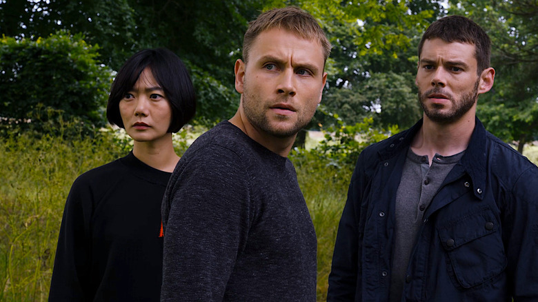 Bae Doona as Sun, Max Riemelt as Wolfgang and Brian J. Smith as Will standing outside lookin concerned in Sense8