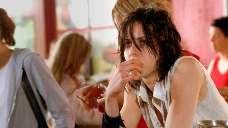 Kate Moennig as Shane with elbows on counter and hand over mouth in The L Word