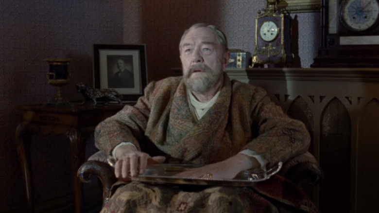 Michael Gambon as King George V sitting in The King's Speech