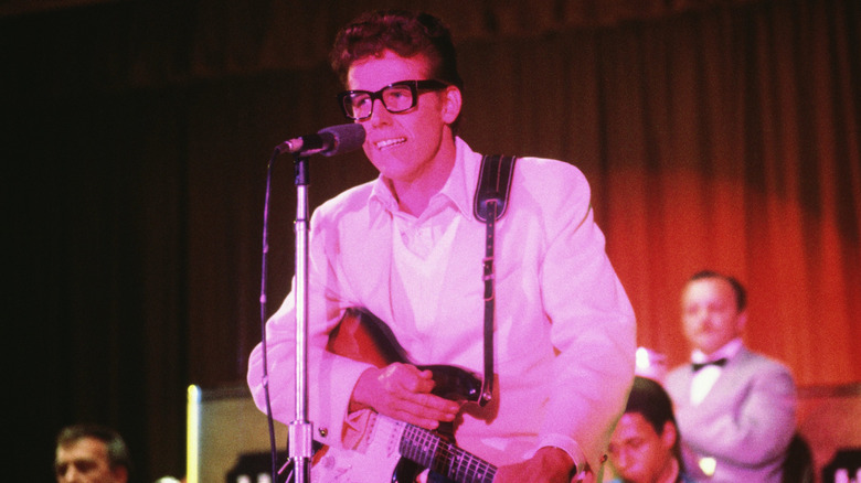 Gary Busey as Buddy Holly singing on stage in The Buddy Holly Story