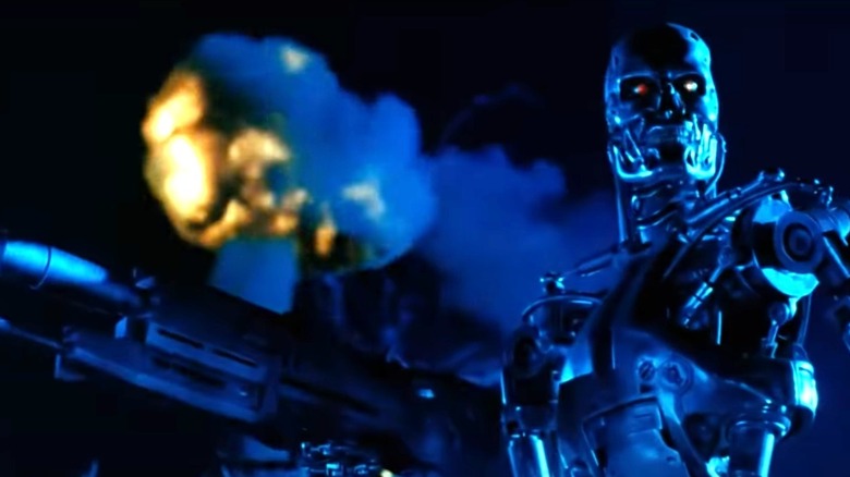 Terminator 2 -- T-800 holding gun, walking on battlefield in future Earth