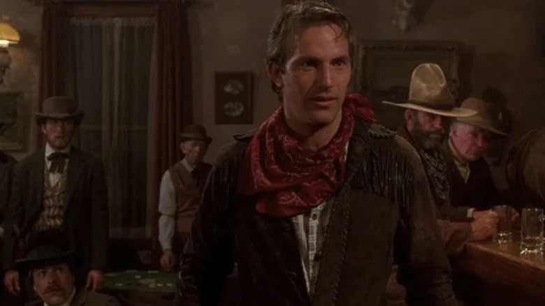 Jake (Kevin Costner) stands in a saloon in Silverado