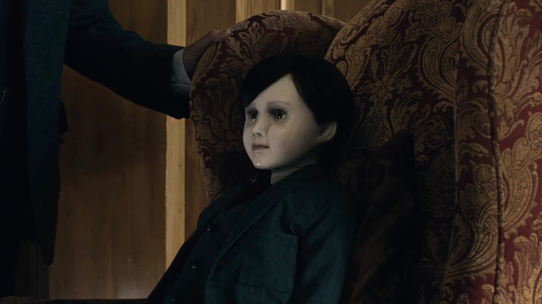 Brahms sitting on a chair in The Boy
