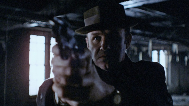 Gene Hackman as Jimmy "Popeye" Doyle pointing a gun in The French Connection