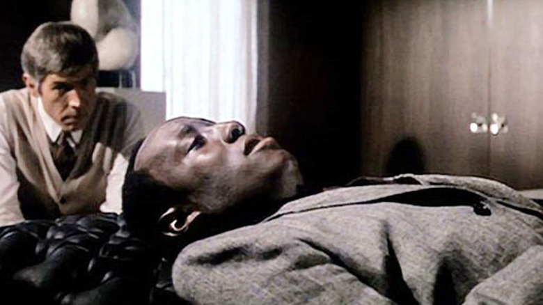 James Coburn as Dr. Sidney Schaefer listening to Godfrey Cambridge as Don Masters in therapy in The President's Analyst