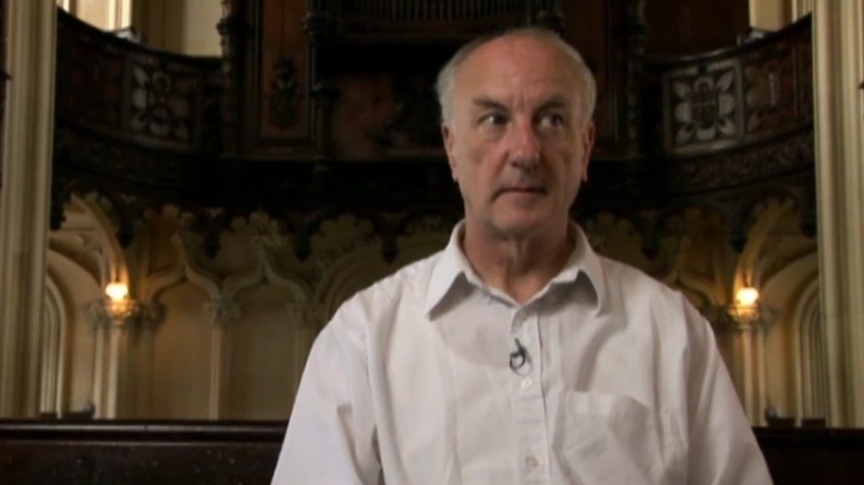 Oliver O'Grady sitting in a church in Deliver Us from Evil