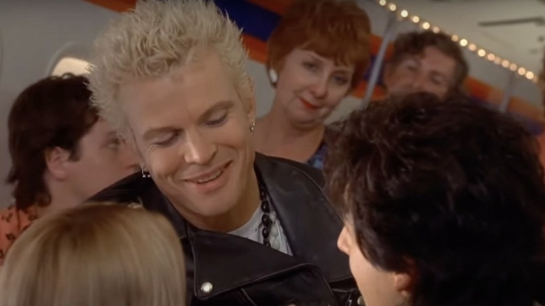 Billy Idol as himself looking at Adam Sandler as Robbie Hart on an airplane in The Wedding Singer