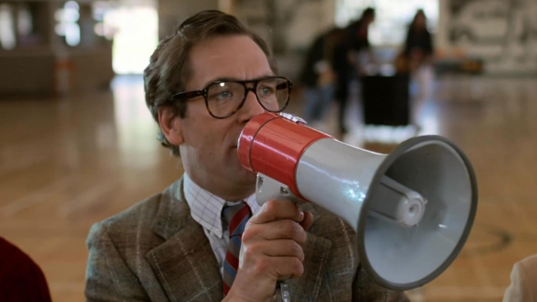 Huey Lewis as a Battle of the Bands judge holding a megaphone in Back to the Future