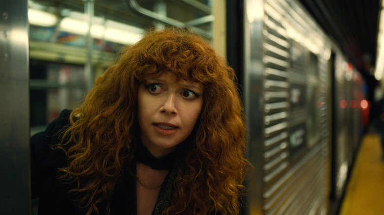 Natasha Lyonne stepping out of subway car looking worried in Russian Doll