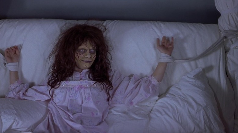 Natasha Lyonne with scary hair and makeup tied to bed in Scary Movie 2